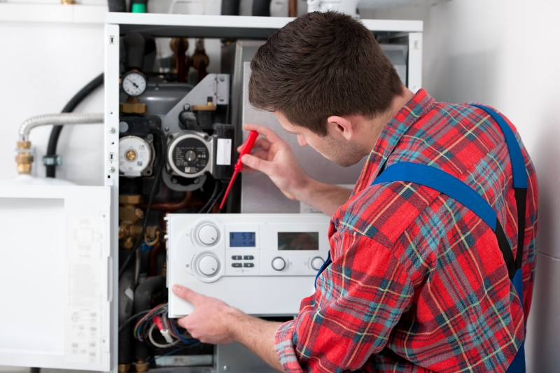 Gas Safe engineer working on a boiler in Goffs Oak